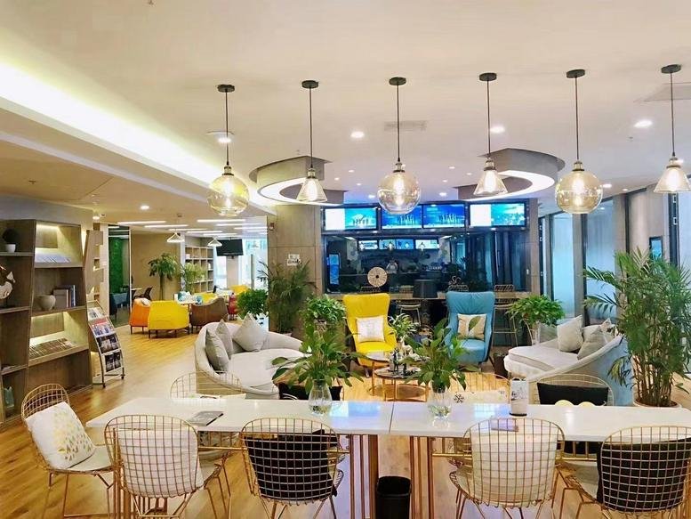 Spacious communal lounge at Number 269, Huaihai Road, Wuhan featuring colorful armchairs and modern pendant lighting.