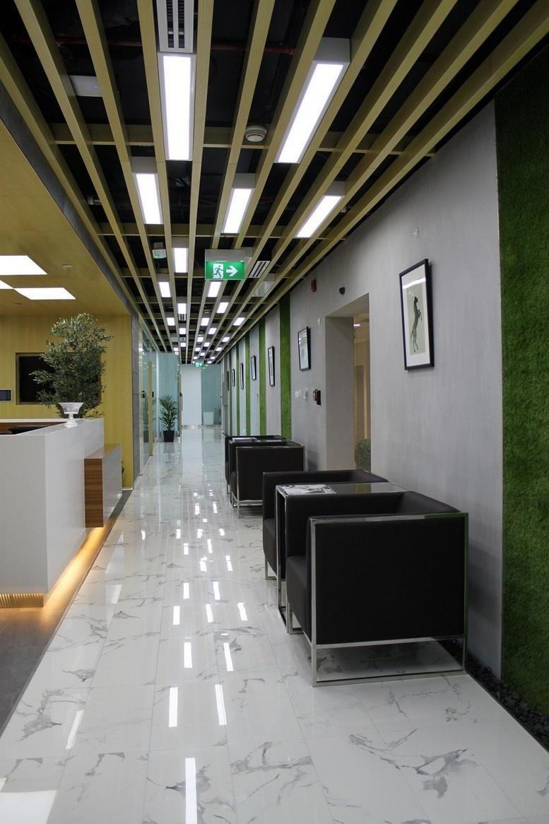 Modern lobby with marble floors and slatted ceiling at 48 Burj Gate.
