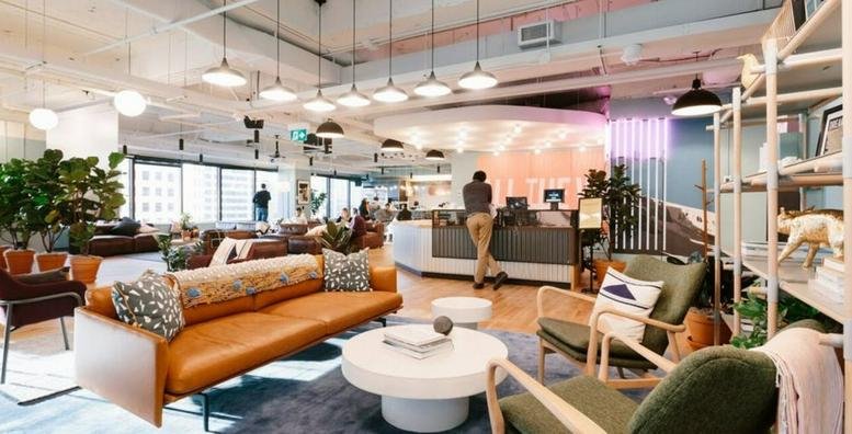 Spacious communal lounge with mid-century modern furniture and a reception desk at 1-24-3, Minami Aoyama.