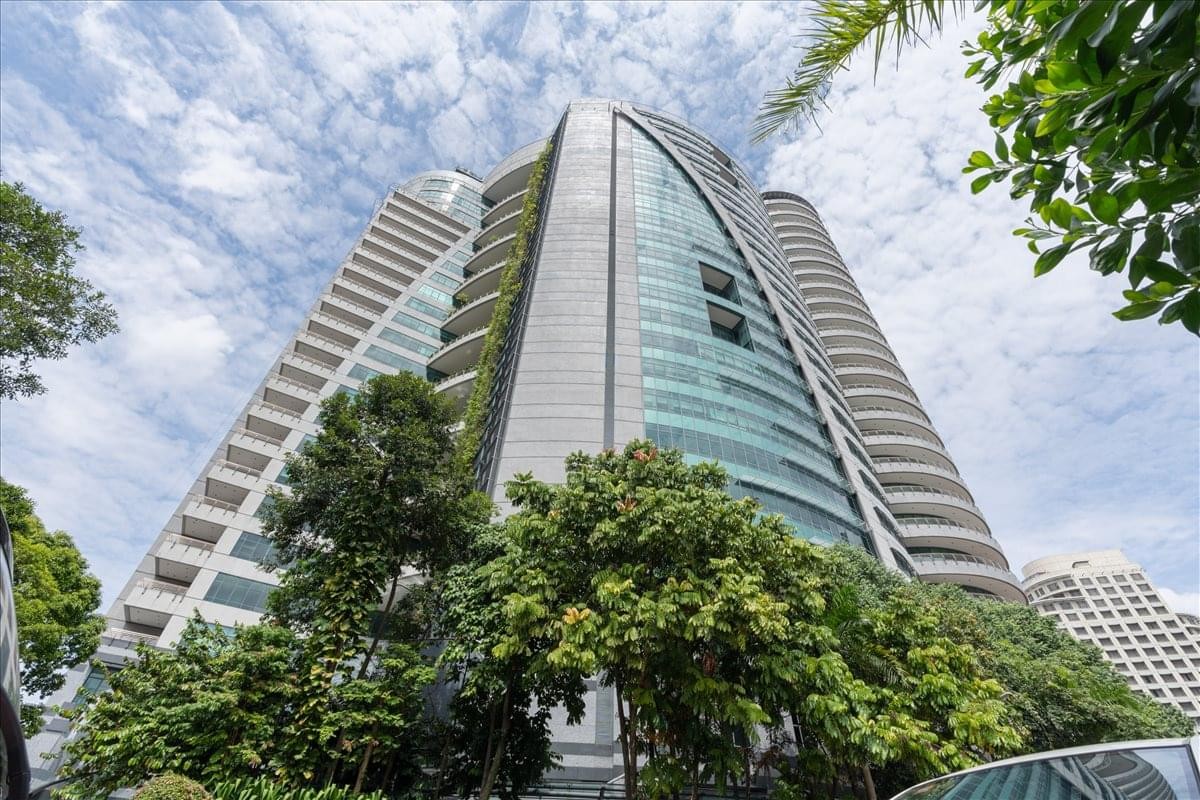A low-angle exterior view of the modern glass and concrete facade of 1 First Avenue, One Utama, Kuala Lumpur.