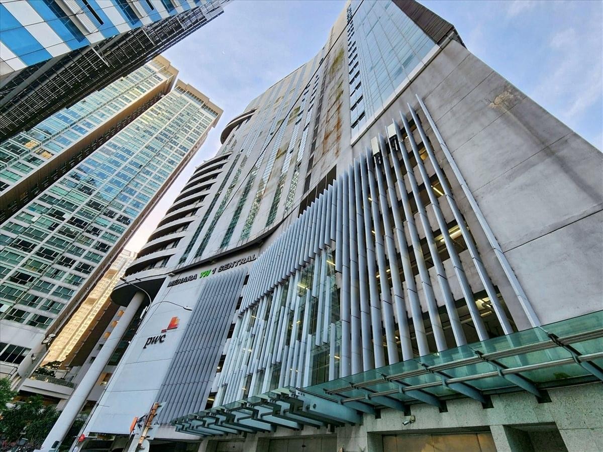 Low angle exterior view of the modern 1 Sentral glass and concrete tower.