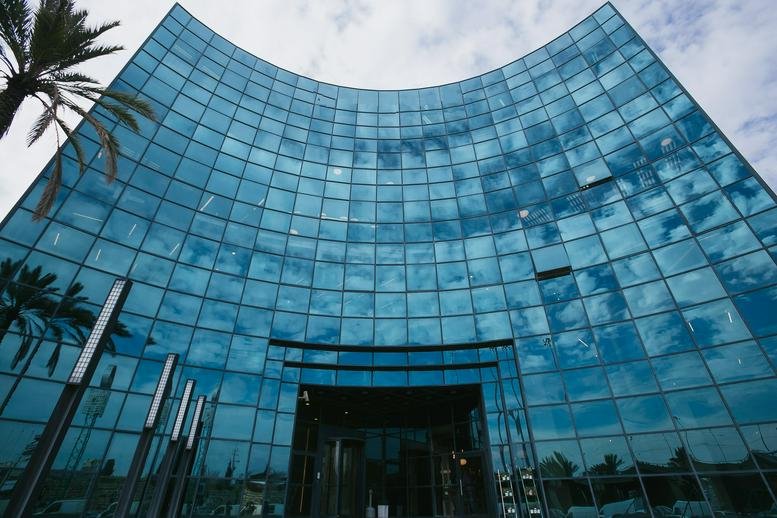 Exterior view of the blue glass-facade building at 1 Shankar Street, Herzliya, Israel, Herzliah.