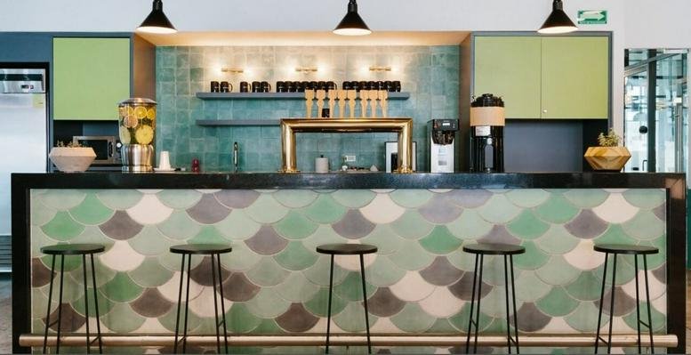 Cafe-style bar at 1 South Wuning Road with green scalloped tile-front and bar stools.