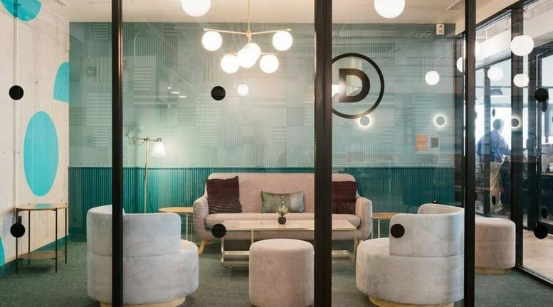 Modern lounge area at 1 South Wuning Road, Jing'an District, Shanghai with plush seating and glass partitions.
