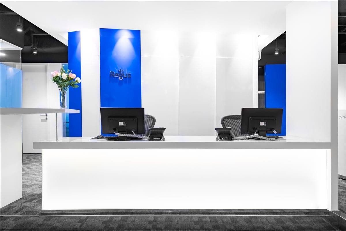 Bright modern lobby area of 101 Thomson Road, United Square, Singapore, featuring a sleek white reception desk.
