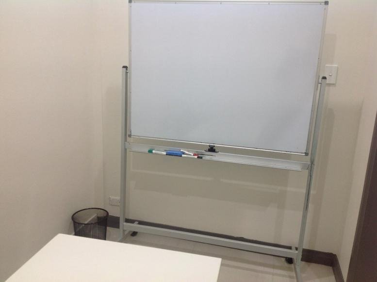 Meeting room at 1023 Botany Road featuring a mobile whiteboard and waste bin.