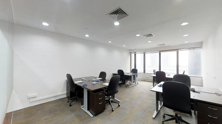Professional open-plan office space at The Arcade Office Tower with multiple workstations.