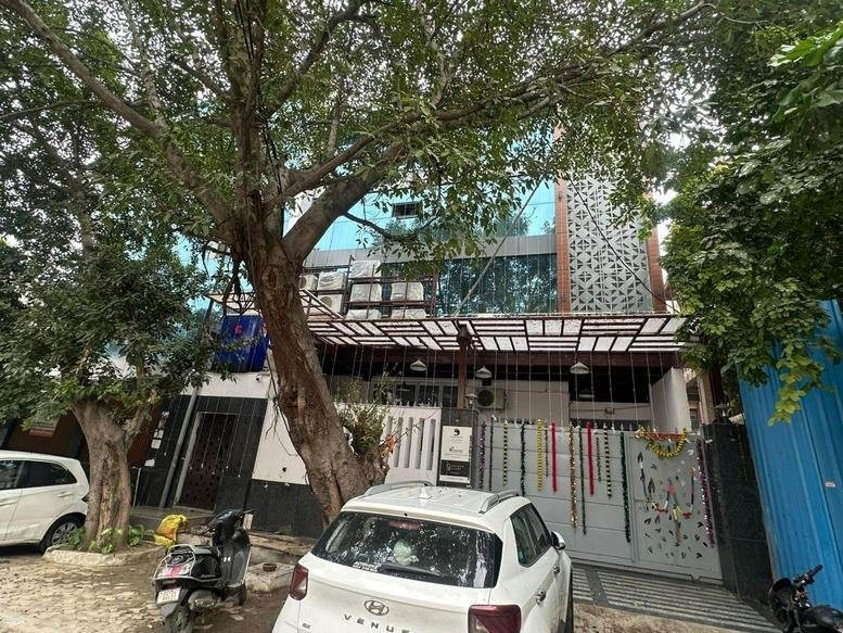 Exterior view of the Golden Glory Coworking Space, 111 F-Block, Sector 8, Noida, India with glass facade.