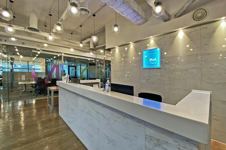 Professional reception desk with white marble finish and integrated lighting.