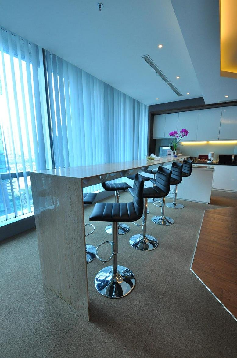 Spacious breakroom at 12-1N Jl. MH Thamrin No. 81 with bar seating and floor-to-ceiling windows.