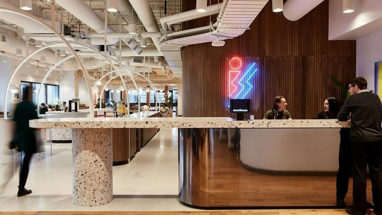 Spacious reception area with neon signage and a textured terrazzo counter at 120 Spencer Street, Melbourne.
