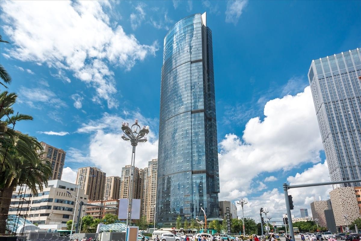 Exterior view of the glass-facade skyscraper at Kunming Square.