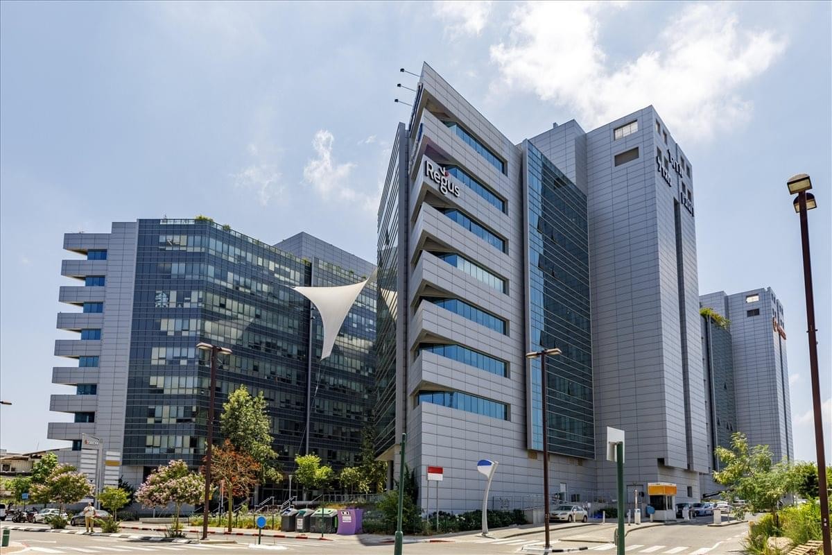 Exterior view of the modern glass and grey-paneled office building at 13 Zarhin Street.