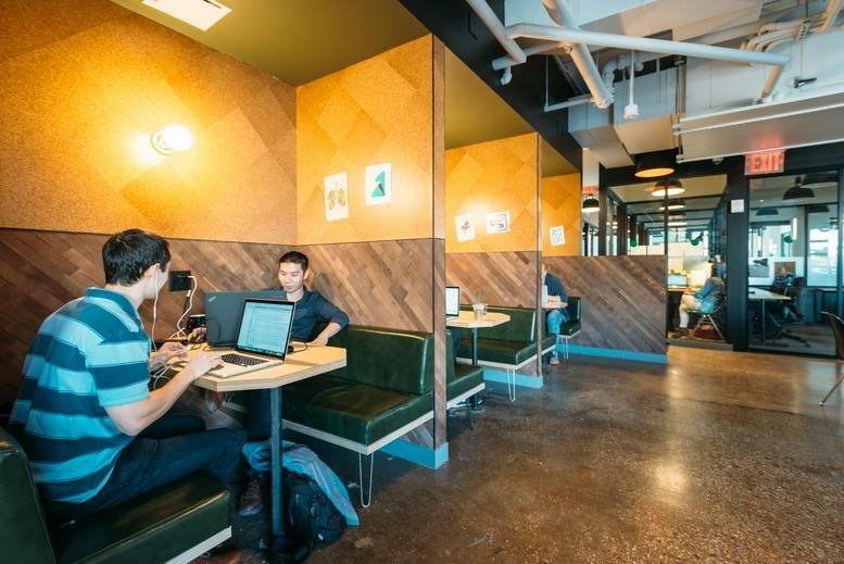Spacious common area at 135 Yanping Road, Jing'an District, Shanghai, China featuring private work booths.