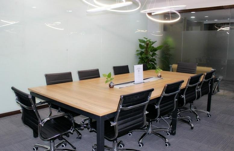 Spacious boardroom at 138 Middle huaihai Road featuring a light wood table and modern ring lighting.