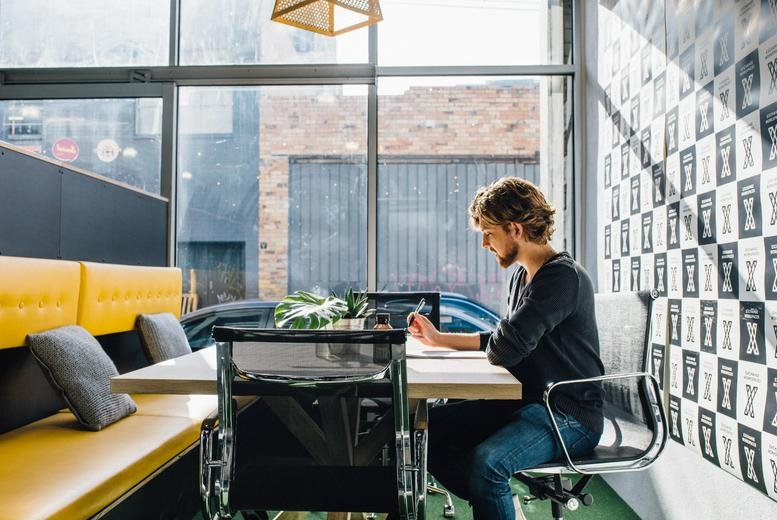 Coworking space at 14 Ellis Street, South Yarra, Melbourne, Victoria with yellow bench seating and large windows.