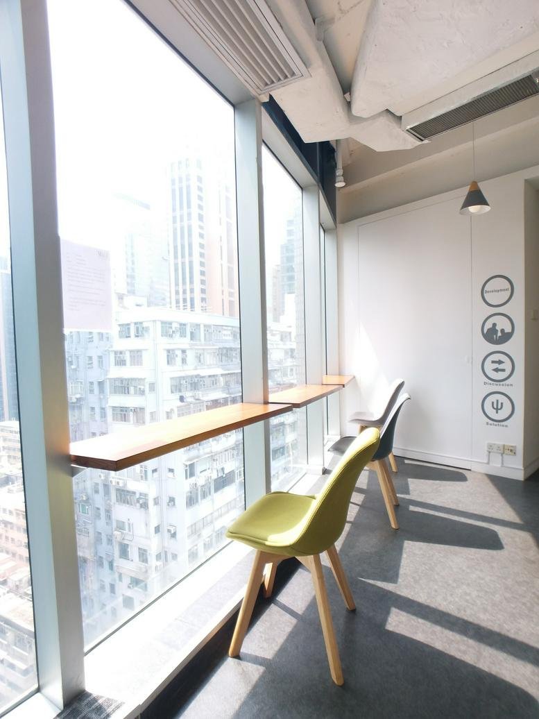 Communal window-side seating at Radio City with a long wooden counter and city views.