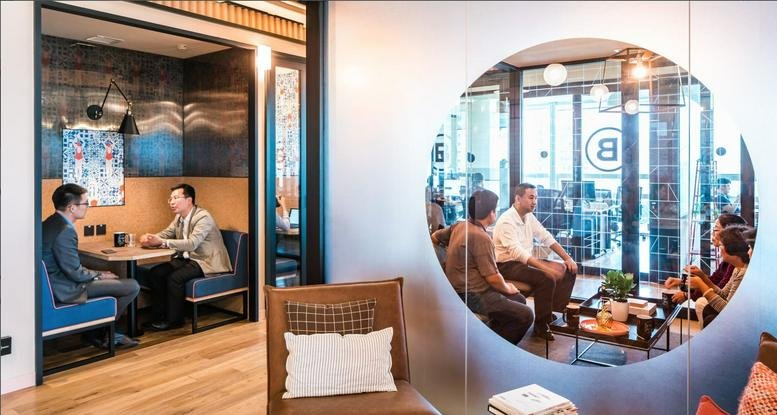 Spacious communal lounge at 14 Teheran-ro, 26 Gangnam-gu, Seoul with circular glass partition and booth seating.