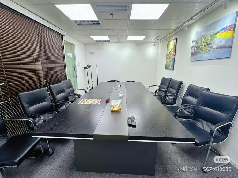 Meeting room at The Point, 14 科學館道 featuring a dark wood conference table and black leather chairs.