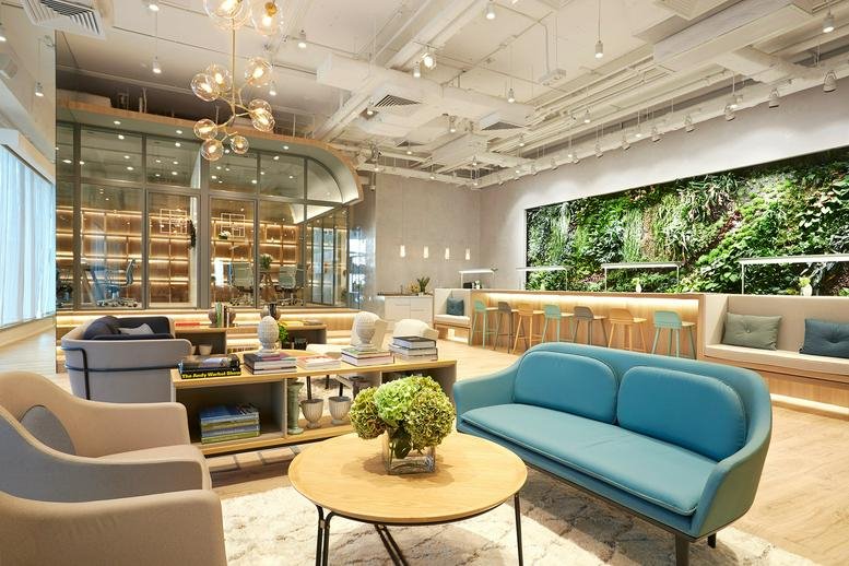 Spacious communal lounge at Soundwill Plaza II – Midtown with colorful seating and a living wall.