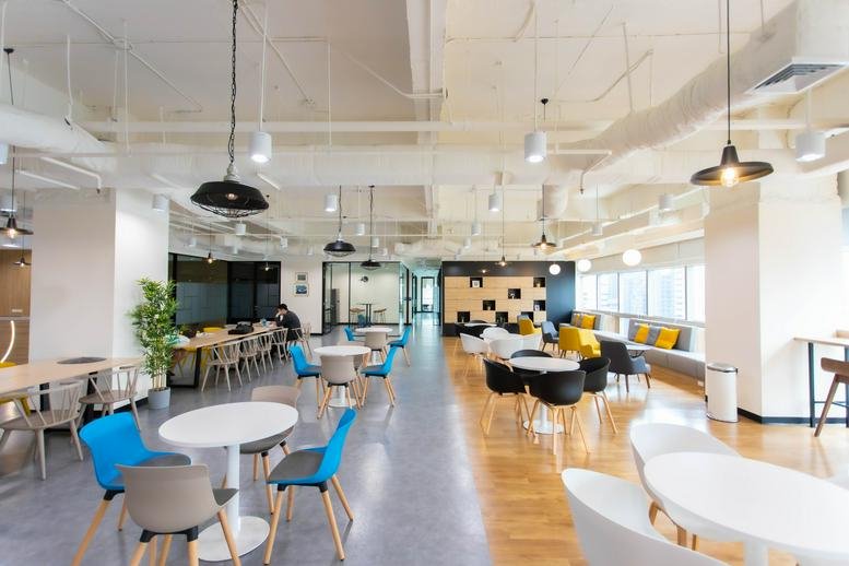 Wide-angle view of a colorful communal lounge at Sermmit Tower, 23rd Floor, 159 Thanon Asok Montri.