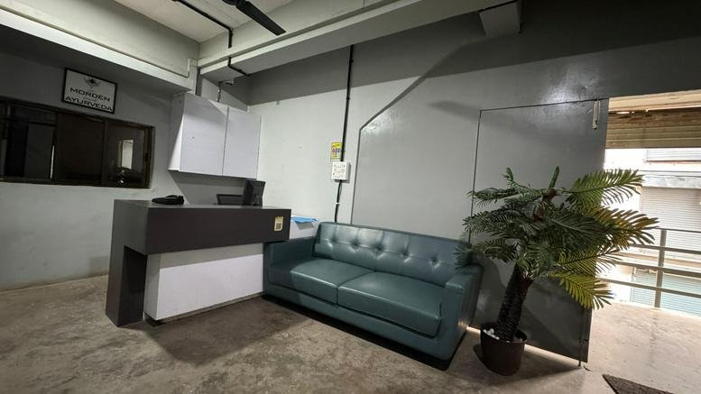 Reception area for 1st Floor, 169 Amrut Udhyog Nagar, Kamrej with a grey desk and teal sofa.