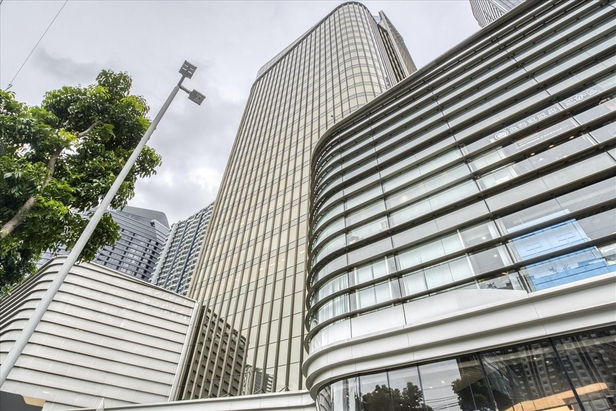 Exterior view of the modern curved glass facade at 1788 New Petchaburi Road.