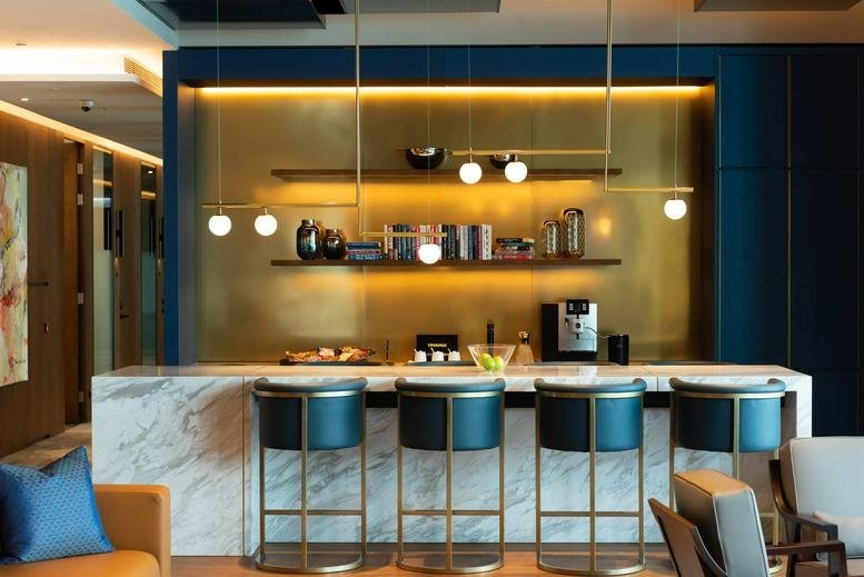 Sleek coffee bar with marble counter and dark teal seating at K11 Atelier, 18 Salisbury Road.