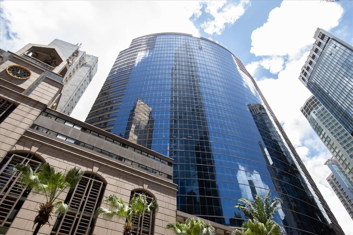 Exterior view of the curved glass facade at Grand Millennium Plaza.