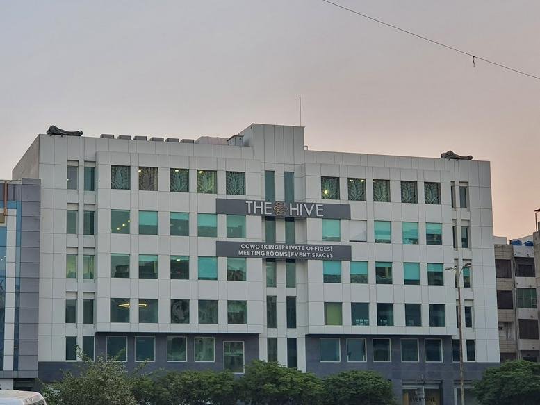 Exterior view of The Hive office building with a white facade and multiple windows.