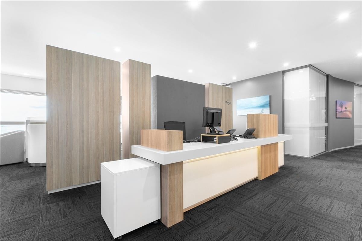 Modern reception desk at the Charles Darwin Centre with warm wood accents and integrated lighting.