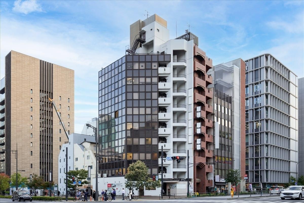 Exterior view of the multi-story 1F, 9F Dai-3 Meiwa Building with its modern glass and stone facade.
