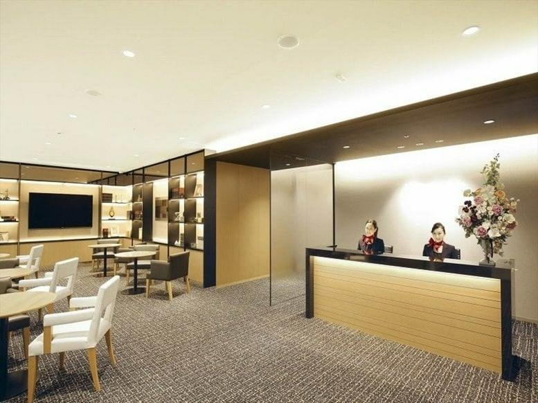 Professional reception area and lobby at Urbannet Nihonbashi 2-chome with warm lighting and wood finishes.