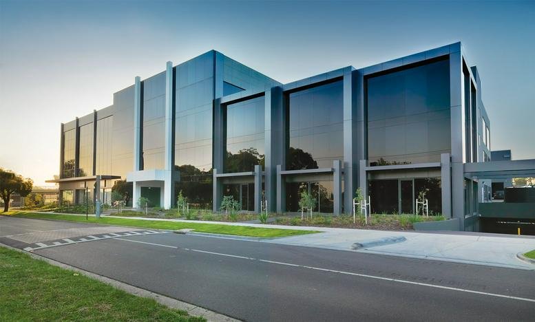 Exterior view of the modern glass-facade office building at 2 Brandon Park Drive.