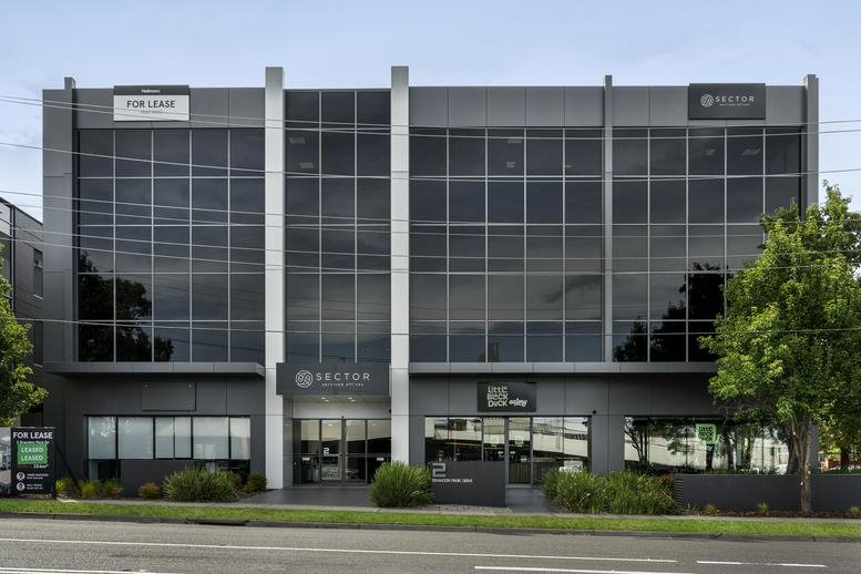 Exterior view of the glass-facade office building at 2 Brandon Park Drive.