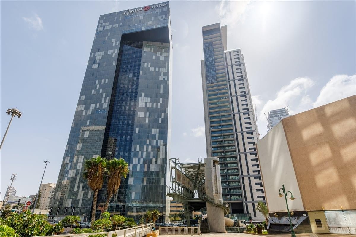 Exterior view of the soaring, modern glass-facade Atrium Tower in the business district.