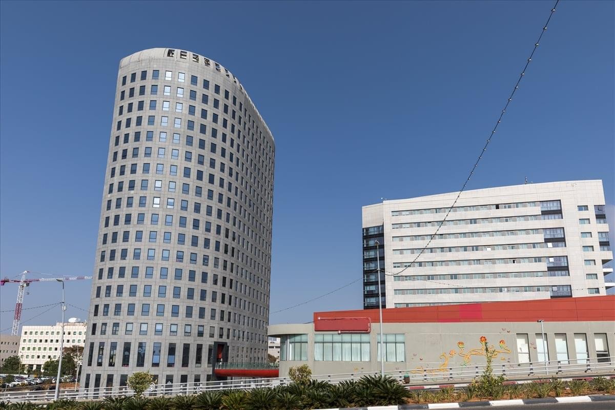 Exterior view of the curved modern skyscraper at 2 Oppenheirmer Street, Tel Aviv.