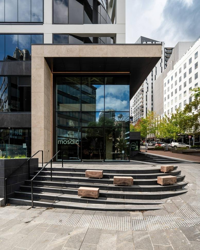 Exterior view of the modern entrance at 2 Wakefield Street with stepped concrete seating.