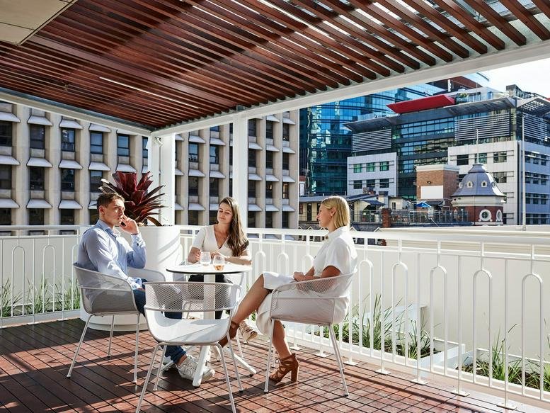 Rooftop terrace at 200 Adelaide Street with wooden pergola and city skyline views.