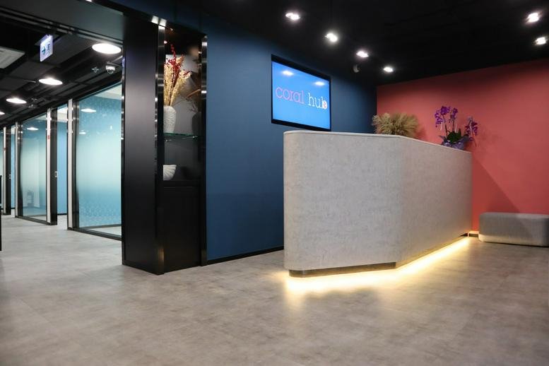 Modern reception desk at Roxy Industrial Centre with warm under-counter lighting and a digital display.