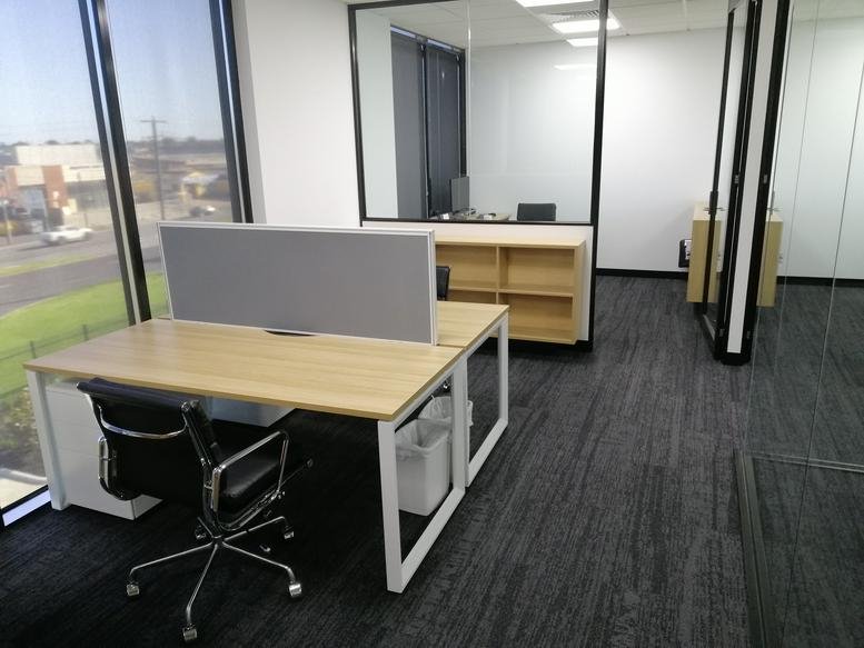 Spacious open-plan workspace at Edge, 210 Boundary Road, Braeside with natural light and partitioned desks.