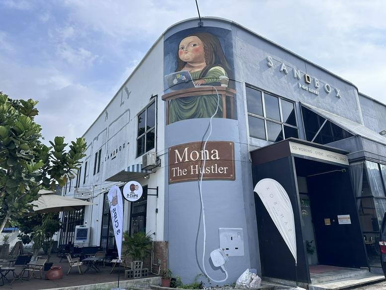 Exterior view of the muraled corner building at 22-1 Jalan Radin Bagus 3.