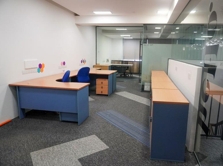 Blue and wood-topped corner workstations at Co Base Workspace, 25 Jalan Pandak Mayah 5.