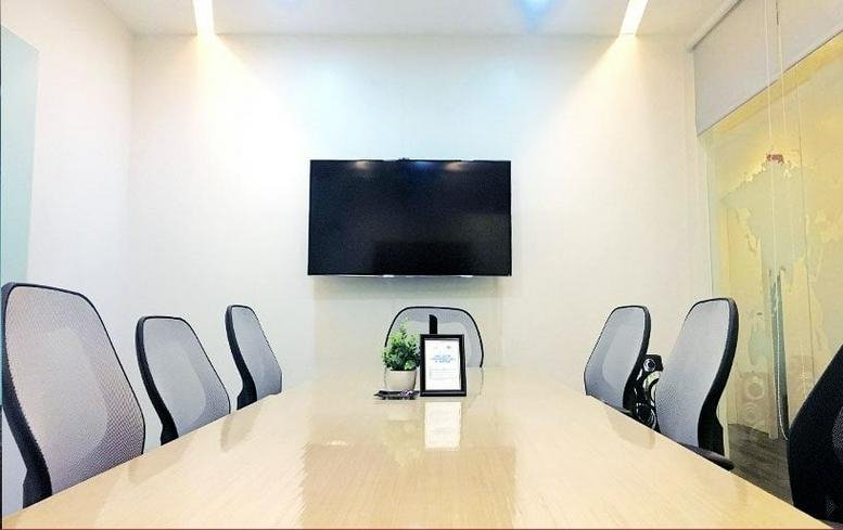 Meeting room at 25th Street & 5th Avenue, Bonifacio Global City, Taguig with six grey chairs and a wall-mounted TV.