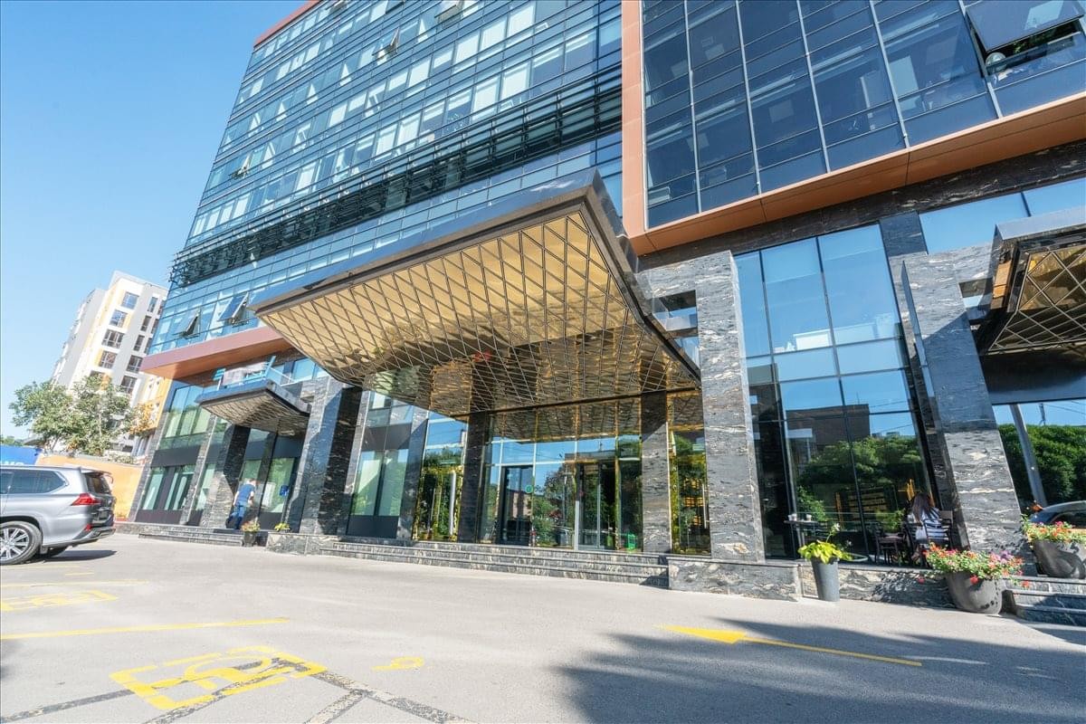 Exterior view of the contemporary glass facade and grand entrance at BNC Plaza.