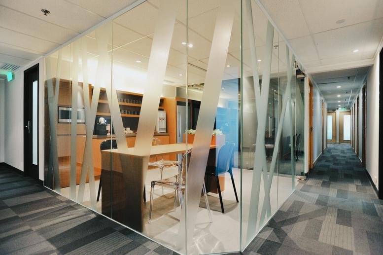 Spacious communal break area at Silvercord Tower 2 featuring glass partitions with decorative frosted patterns.