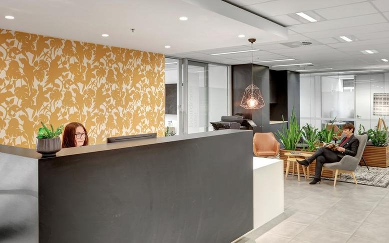 Bright reception desk at 307 Queen Street, Brisbane, Queensland with patterned yellow wallpaper.