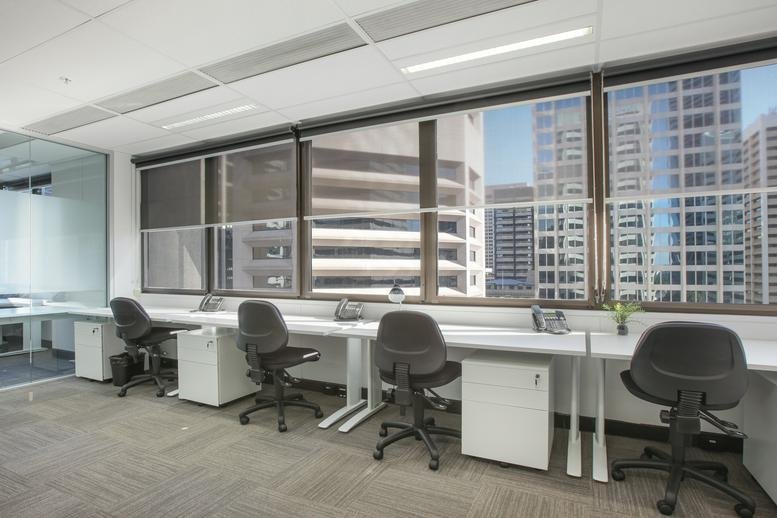 Wide view of the modern reception at 307 Queen Street, Brisbane, Queensland featuring a dark front desk.