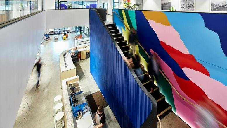 Interior view of Level G-2, 310 Edward Street featuring a grand staircase and vibrant mural.