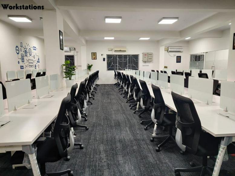 Spacious open-plan workspace at Unitus Technology Center with long rows of desks and ergonomic chairs.